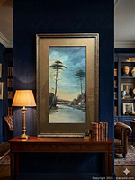 Framed vertical landscape painting on wall above console table
