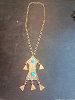 Full view of brass pendant necklace with chain