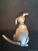 rear view of pewter dog pin showing articulated tail