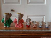 Front view of all six Babar flocked figures lined up with ruler for scale
