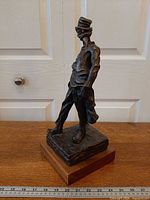 Full view of Ratapoil sculpture on wood base
