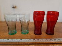 Four glasses aligned with ruler for scale