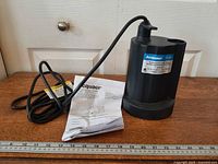 Pump with power cord and manual on table