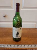 Full view of sealed green glass wine bottle with Chateau Du Golf label showing contents