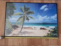 Full view of framed beach print with measuring tape showing width