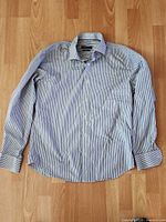 Full view of Bugatchi blue striped dress shirt laid flat