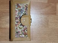 Front view closed showing floral fabric panel and snap flap