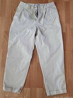 Full front view of beige chinos laid flat