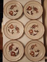 Six Autumn Fair plates arranged front view