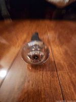 Clear acrylic roller head showing ribbed surface and center axle
