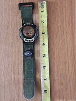 Full view of watch with measuring tape showing strap length
