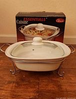 Casserole set assembled on chrome rack in front of original box