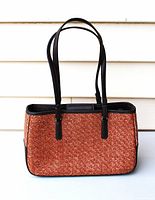 Front view of Liz Claiborne woven raffia handbag showing shape, material and straps