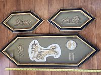 Three framed relief pieces overall view