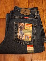 Folded pair of Wrangler Five Star jeans with size and fit tags visible