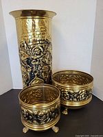 umbrella stand and two planters grouped