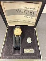 Watch and pendant in Bulova presentation box with paperwork