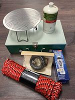 Full lot showing stove, toaster, propane cylinder, rope, flashlight, hose
