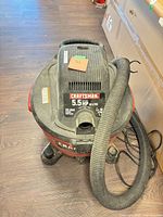 Front view showing Craftsman logo, 5.5 HP label, hose attached