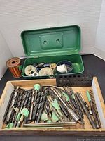 Tray of large twist drill bits, spool of copper wire, hole saw kit in green case, drill index block