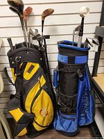 Both golf bags filled with clubs