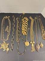 All necklaces laid out showing length, link styles, pendants