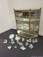 Cabinet and bulk of crystal figurines arranged in front