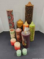 Group of all twelve candles showing variety of sizes, colours and patterns