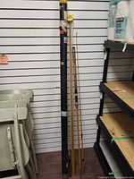 Overall view of rod tube and fishing rods standing against wall