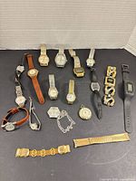Group shot of seventeen timepieces and loose bands