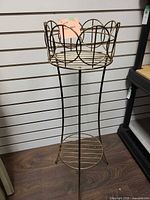 Full view of brass-tone metal plant stand