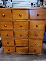 Front view showing 15 drawers and knob pulls
