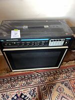 Front three-quarter view of Acoustic amplifier showing cabinet, control panel and overall wear