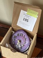 Agate stone clock in cardboard box showing dial and auction tag