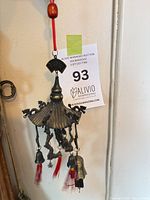 Full view of metal wind chime showing canopy, hanging bells, dragon charms, red tassels