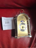 Front view of Bulova brass and chrome mantel clock with moon phase dial