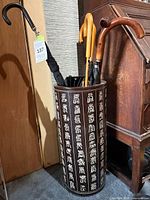 Full view of cylindrical ceramic umbrella stand displaying Chinese characters