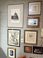 Full wall view showing eight framed artworks