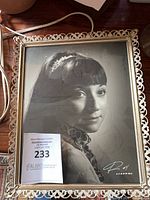 Front view of framed monochrome portrait photograph showing signature and frame detail