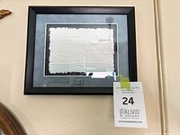 Full view of framed embossed loon artwork on wall