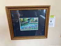 Framed landscape water lily print in gold ornate frame with double mat shown hanging on wall