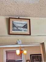 Full view of framed bridge print on wall
