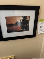 Framed print on wall showing silhouette landscape