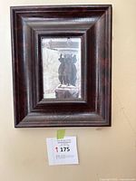 Front view of framed photograph showing artwork and mahogany-finished wood frame