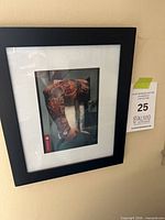 Entire framed photograph showing black frame, white mat, glazing and artwork