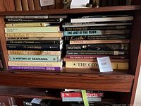 Full view of both stacks of large-format books on shelf