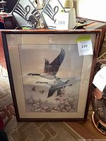 Full view of framed print showing birds in flight and floral scene