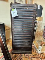 Full view of dark brown wooden rotating rack