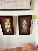 Two framed prints on wall: forest trees and horse with foal