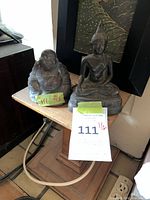 Both bronze Buddha figurines on small pedestal